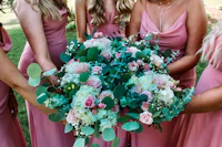 bridesmaids holding pink and green bouquets